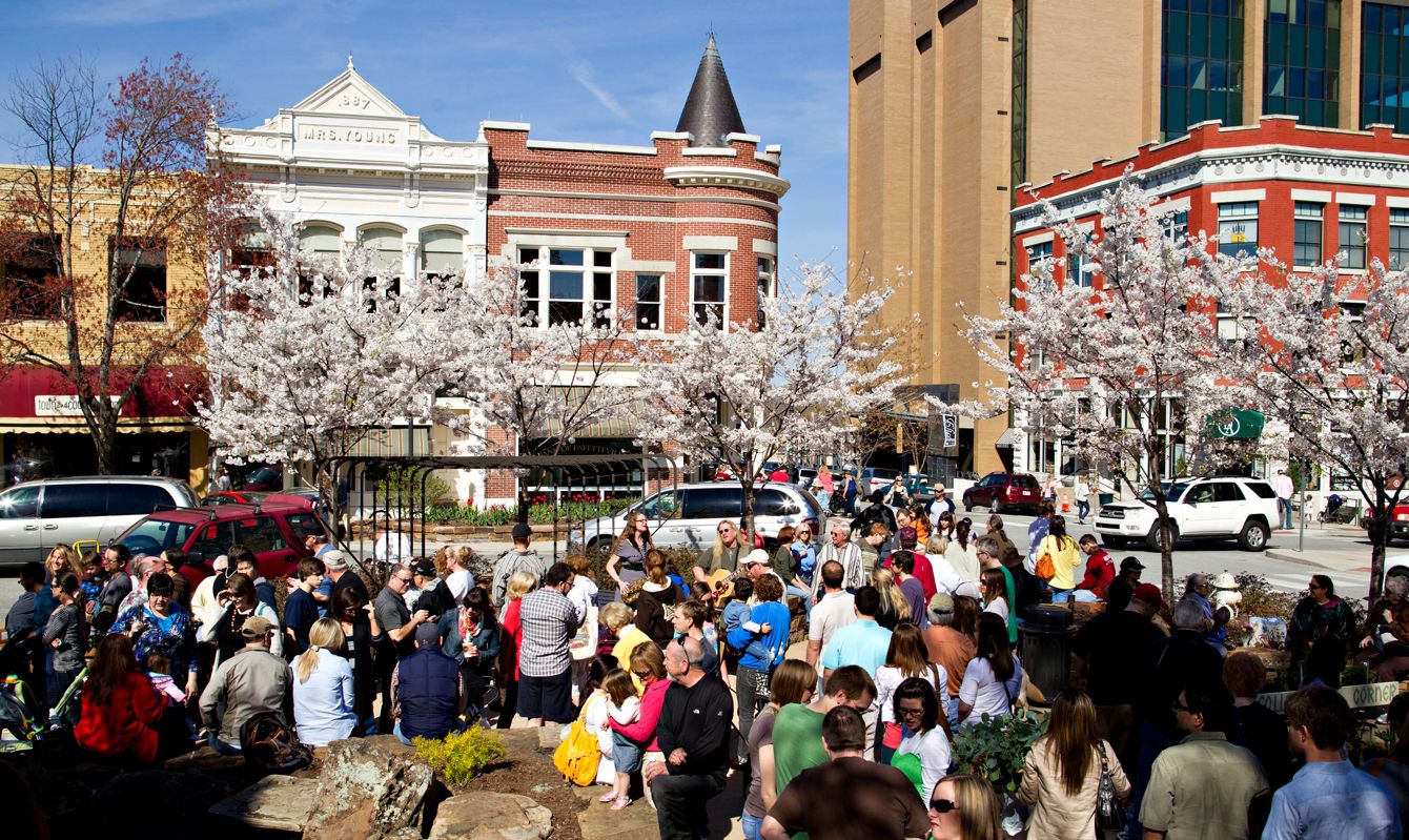 Residents enjoy the saturday morning Farmers Market on the square in downtown Fayetteville, Arkansas