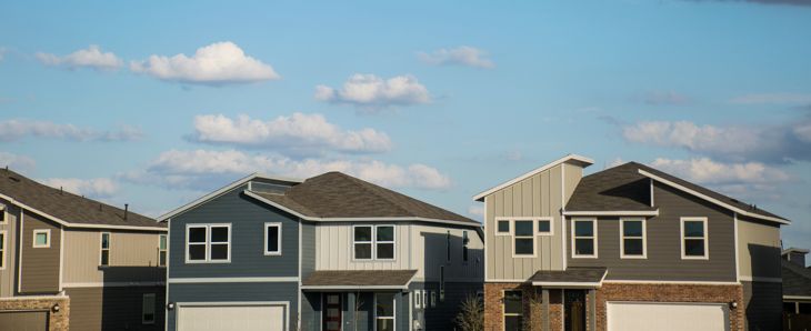 On a perfect afternoon daytime with sunshine and a few puffy clouds . Modern rooftops and architecture on new homes in suburbia neighborhood perfect day dream homes that we would all love to live in